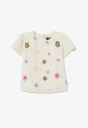 Witte blouse met korte mouwen, versierd met bloemenborduursel in roze, paars en groen. Heeft een ronde halslijn en een sluiting met knoop aan de achterkant.