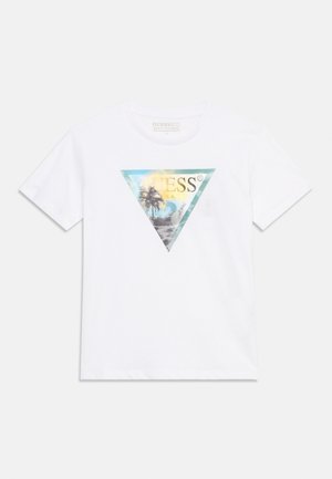 Tricou alb cu mâneci scurte, cu un grafic triunghiular multicolor care prezintă palmieri și cuvântul "GUESS" scris cu litere mari.