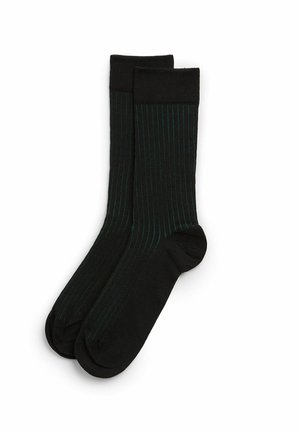 Schwarze Socken mit grünen vertikalen Streifen, ausgestattet mit einer glatten Textur und einem gerippten Bündchen. Standardmäßige Crew-Länge für einen bequemen Sitz.