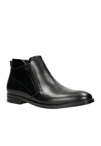 Schwarze Leder-Stiefelette mit glatter Oberfläche, seitlichem Reißverschluss, strukturiertem Design und niedrigem Blockabsatz. Mit dezenten Steppnähten.