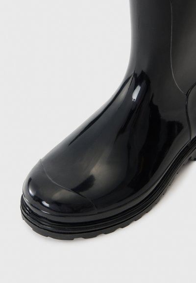 Black rubber boot with a glossy finish, rounded toe, and textured black sole. Features a seamless design and smooth surface.