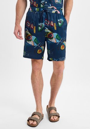 Marineblaue Badehose mit einem bunten, abstrakten Muster aus Augen und Wirbeln, elastischem Bund und seitlichen Taschen.