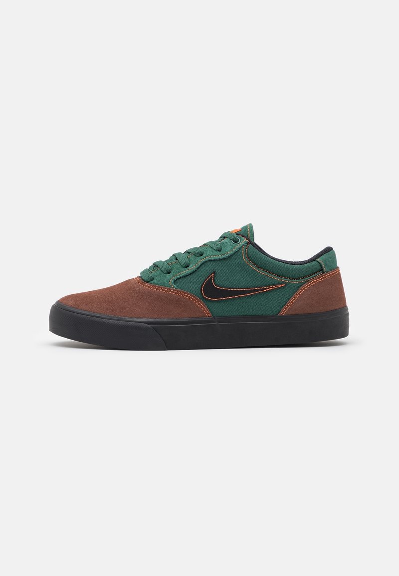 Brown suede and green canvas sneaker with a black rubber sole, orange stitching, and a black Nike swoosh on the side.