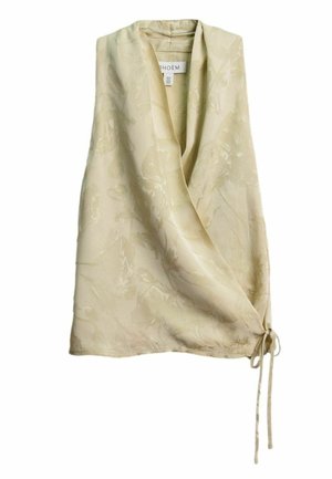 Krémová bezrukávová zavinovacia blúzka s jemným kvetinovým žakárovým vzorom a detailom na bočné viazanie.