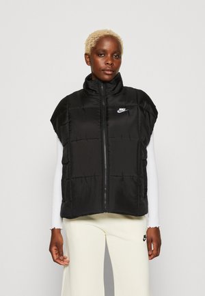 Zwarte, mouwloze puffer vest met een hoge kraag, ritssluiting en voornaad. Heeft een klein wit Nike-logo op de borst.