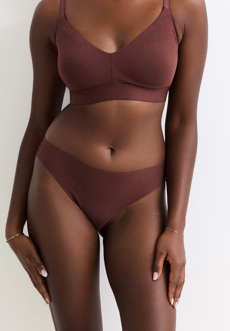 Bruine stoffen bralette met dunne bandjes en bijpassende bruine bikini-stijl slips. Gladde textuur, naadloos design en gemiddelde bedekking.