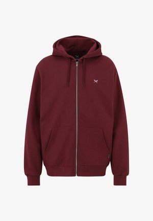 Maroon zip-up hoodie with drawstring hood, front pockets, ribbed cuffs, and small crossed scissors logo on the left chest.