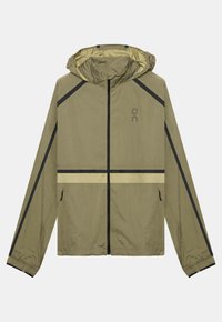 Veste à capuche vert olive clair avec fermeture éclair noire, bandes réfléchissantes noires et jaunes sur les manches et la taille, poches latérales zippées.