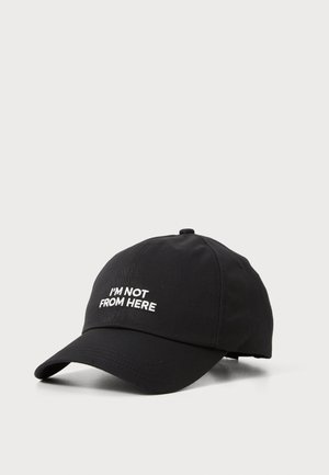 Black baseball cap made of fabric, featuring white embroidered text reading "I'M NOT FROM HERE" on the front. Curved brim design.