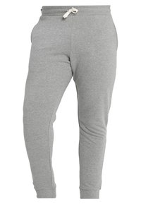 Pantalones de chándal grises hechos de una mezcla de algodón, con un diseño ajustado, bolsillos laterales y una cinturilla con cordón.