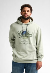 Sudadera verde claro con un gráfico frontal que representa un paisaje y el texto "Miami U.S.A." Cuenta con un bolsillo canguro y capucha con cordones.