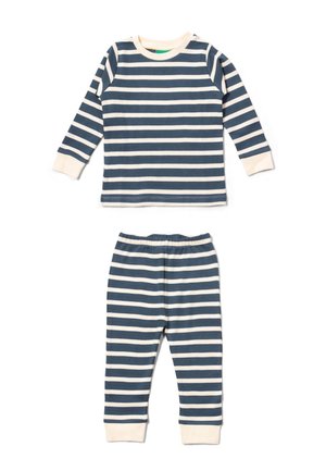 Striped pajama set in navy and cream. Long-sleeve top with round neckline and cuffs; matching pants with elastic waistband and cuffed ankles.
