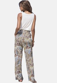 Floral-patterned trousers in earthy tones of brown, green, and blue, featuring a relaxed fit and elastic waistband for comfort.