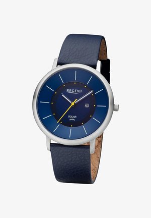 Montre solaire à cadran rond bleu avec boîtier argenté, aiguille des secondes jaune, affichage de la date et bracelet en cuir vegan marine texturé.