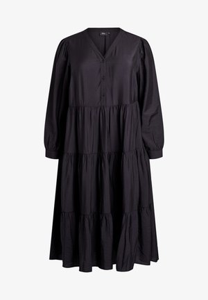 Melnā, garām piedurknēm kleita ar V-veida izgriezumu, pogu priekšpusi un daudzlīmeņu dizainu. Izgatavota no gludas auduma, ar sakropļotām piedurknēm un jostasvietu.