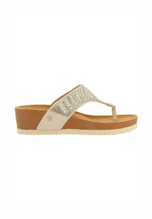 Sandales compensées beige avec une bride ornée de perles, semelle intérieure texturée et semelle en caoutchouc brun clair, avec un logo subtil sur le côté.