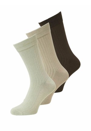 Drie paar geribbelde sneakersokken in lichtbeige, middelbeige en donkerbruin, overlappend en schuin naar rechts weergegeven.