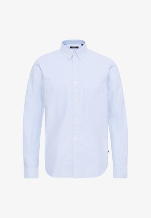 Gai zila pogājamā krekla ar garām piedurknēm, klasisku apkakli un baltām pogām. Izgatavots no gluda auduma ar noapaļotu apakšmalu un minimālu apdari.