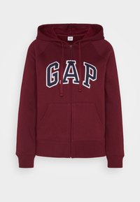 Felpa con zip color bordo in misto cotone, caratterizzata dal logo "GAP" in bianco e blu navy, con lacci, tasche a marsupio e polsini a costina.