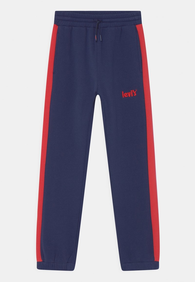 Pantalon de survêtement bleu marine avec des bandes latérales rouges, taille élastique, cordon de serrage et petit logo Levi's brodé sur la partie supérieure de la cuisse gauche.