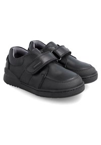 Zapatos de cuero negro con forma redondeada, correas de velcro, superficie texturizada y suelas de goma que proporcionan agarre y estabilidad.
