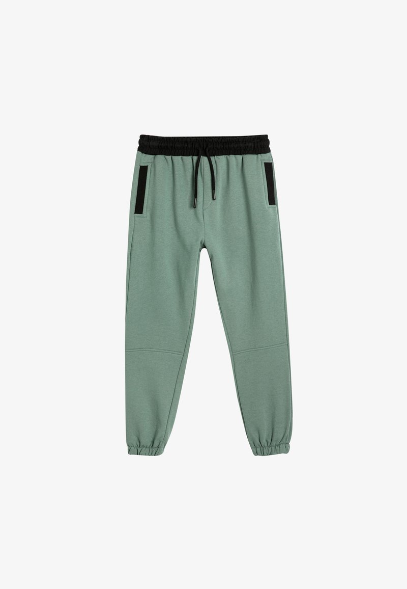 Light green jogger pants with elastic waistband, black drawstring, and side pockets featuring black accents. Cuffed at the ankles.