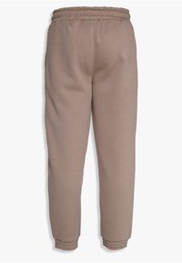 Hellbraune Jogginghosen mit einem elastischen Bund, tapered Beinen und gerippten Bündchen. Hergestellt aus weichem Stoff und ausgestattet mit Seitentaschen.
