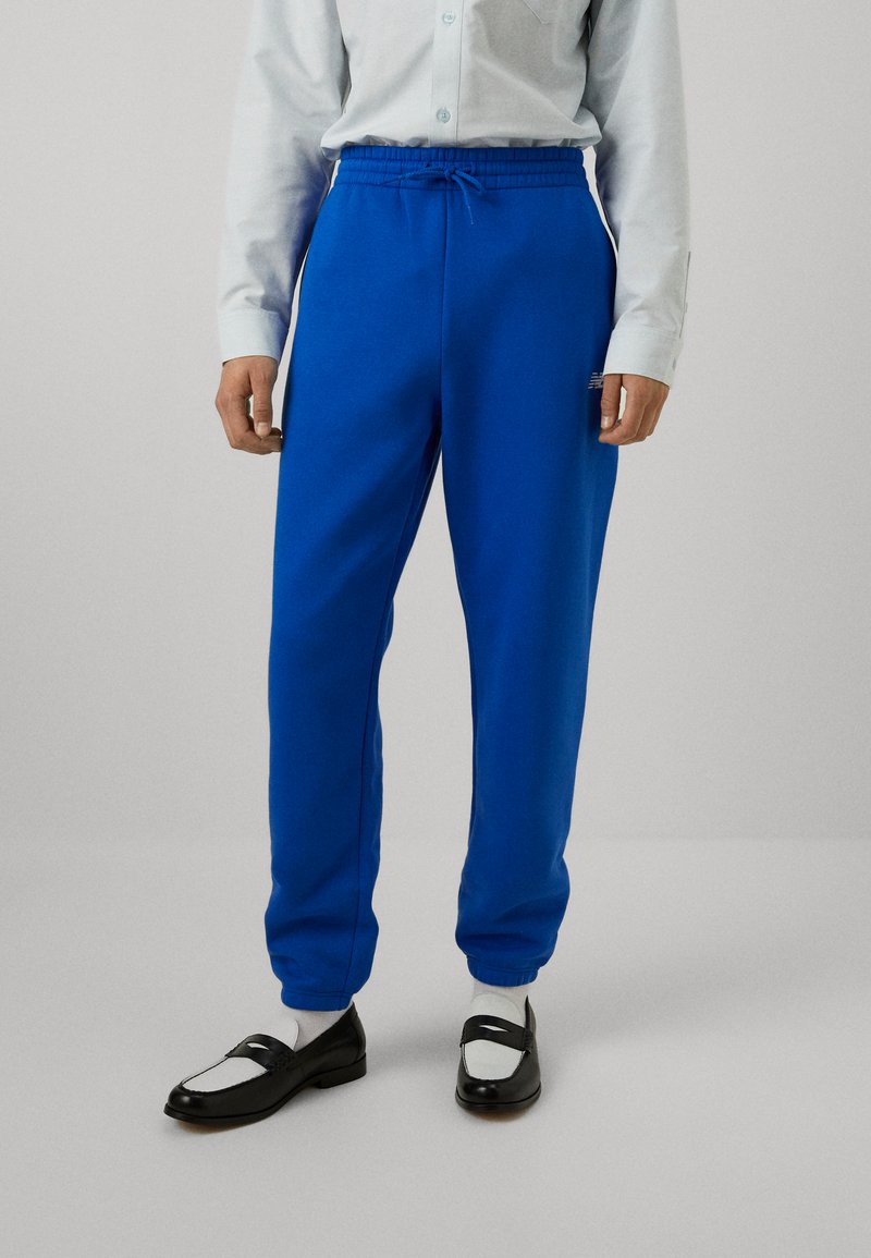 New Balance SPORT ESSENTIALS - Teplákové kalhoty - blue