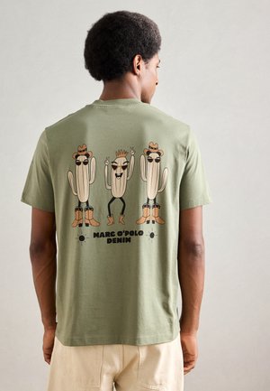 Olive green cotton t-shirt featuring a cartoon design of cacti with hats and boots, printed on the back, along with 'MARC O'POLO DENIM' text.