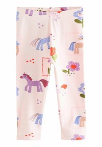 Lichtroze leggings met speelse illustraties van eenhoorns, bloemen en kleurrijke patronen in verschillende maten en vormen.
