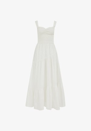 Robe maxi blanche sans manches avec corsage froncé, encolure carrée et jupe à volants avec de subtils détails ajourés.