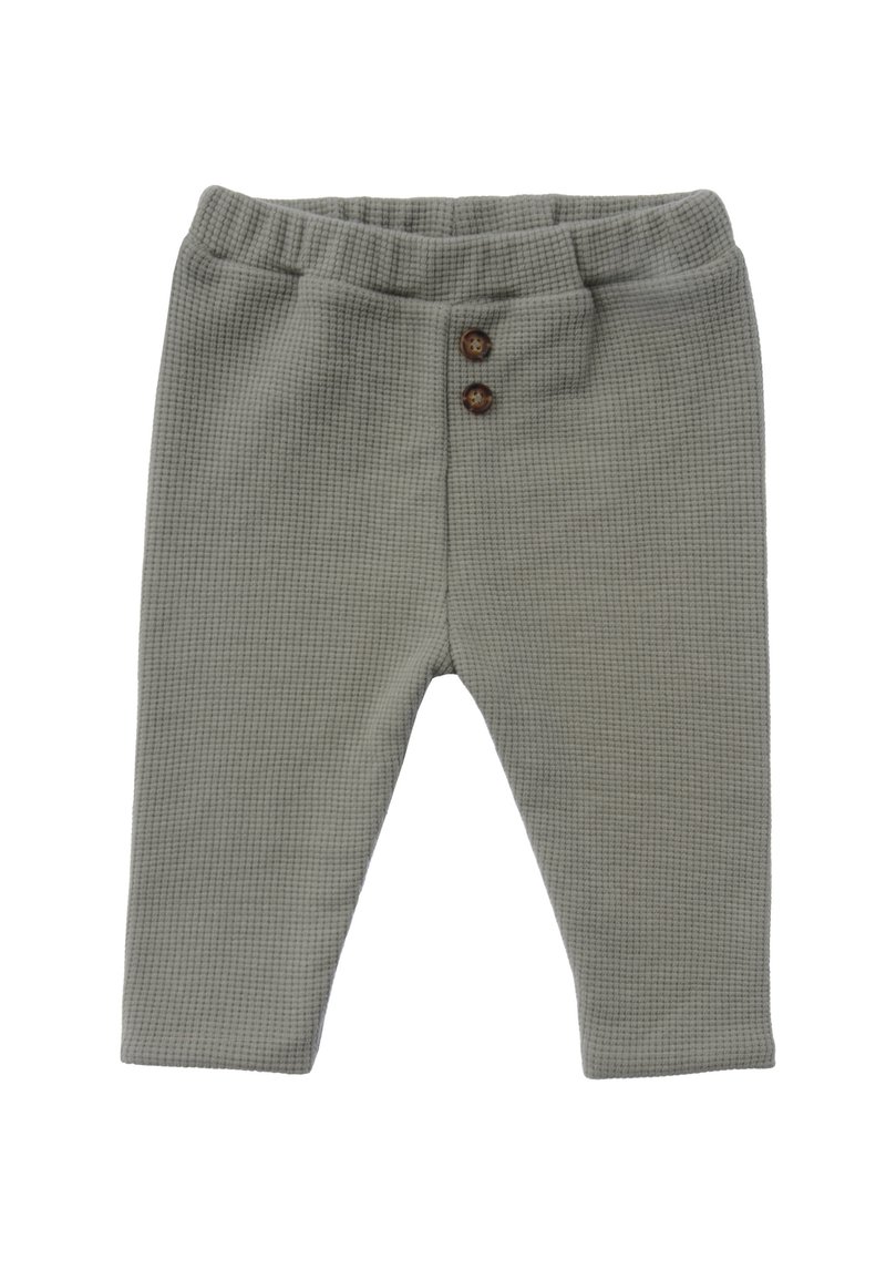 Grüne, waffelstrukturierte Hose mit einem elastischen Bund und zwei braunen Knöpfen an der Vorderseite. Mit konischem Bein design.