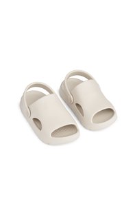 Beige Sandalen mit offener Zehe, strukturiertem Fußbett, flexiblem Kunststoffmaterial und hinterem Fersenriemen für zusätzliche Stabilität. Glattes, rundes Design.