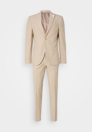 Beženo laneno saka s posameznim gumbom in zarezanimi reverji, dvema sprednjima žepoma in hlačami slim fit. Vključuje majhen cvetlični detajl.