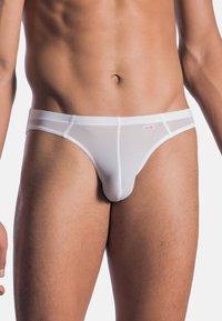 Weiße Slips aus einem glatten, dehnbaren Material, mit einem niedrigen Bund und einem dünnen Taillenbund mit dezentem Branding.