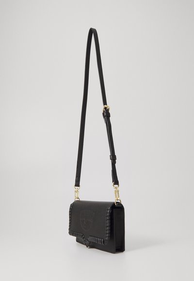 Black leather crossbody bag with a rectangular shape, embossed design, and braided edge detailing. Adjustable strap and gold hardware accents.