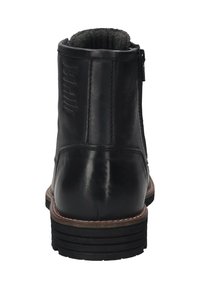Botte noire en cuir à chevilles avec fermeture éclair à l'arrière, semelle intermédiaire en cuir marron cousue, semelle en caoutchouc noire texturée et doublure intérieure noire rembourrée.