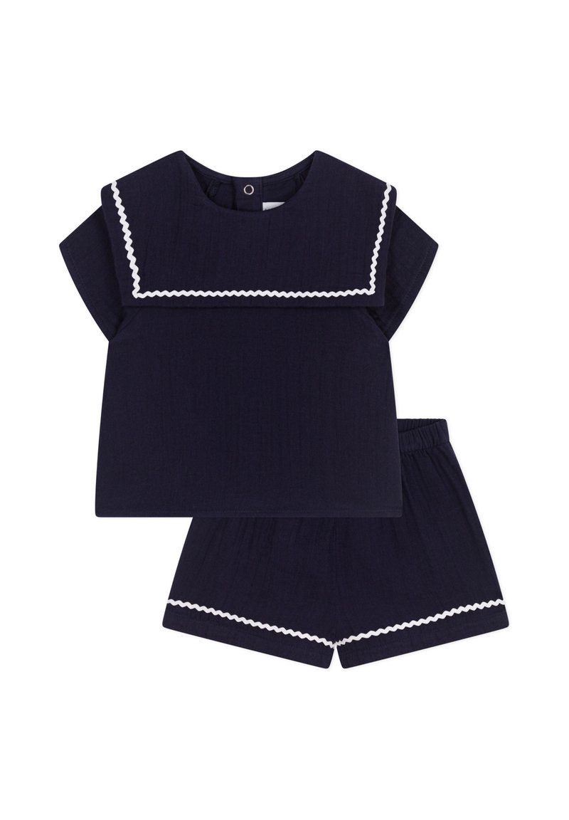 Completo due pezzi blu navy con una maglietta a maniche corte caratterizzata da un colletto bianco a onde e pantaloni corti con vita elastica abbinati. Tessuto testurizzato.