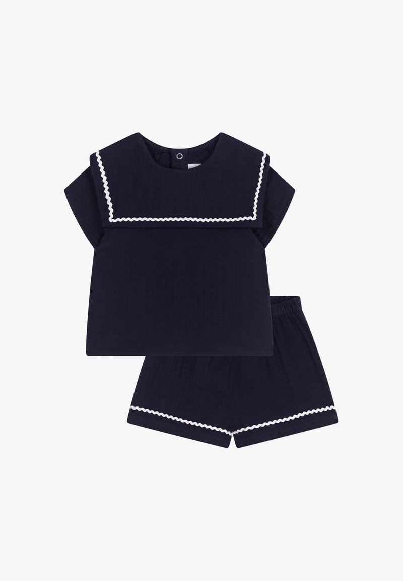 Completo due pezzi blu navy con una maglietta a maniche corte caratterizzata da un colletto bianco a onde e pantaloni corti con vita elastica abbinati. Tessuto testurizzato.