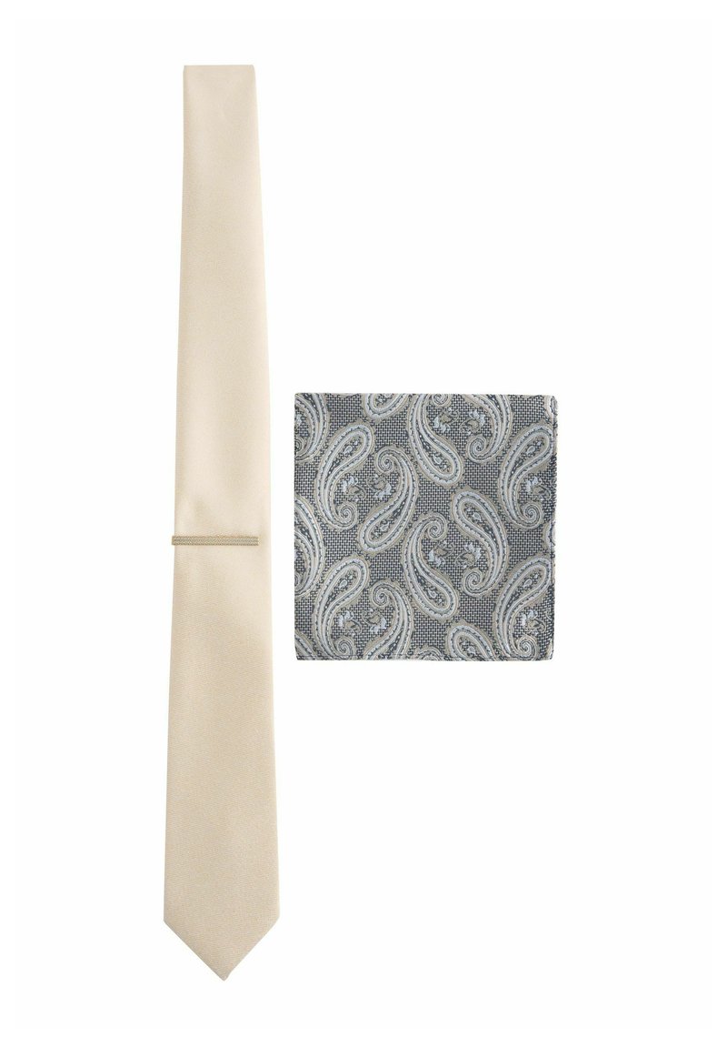 Cremfarbener, schmaler Krawatte mit texturiertem Finish, kombiniert mit einem grauen Paisleymuster-Taschensquare, das aufwendige weiße Muster aufweist.