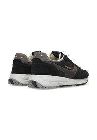 Sneaker in suede nero e grigio con una suola intermedia bianca, dotato di accenti a forma di stella dorata, punta arrotondata e suola in gomma testurizzata.