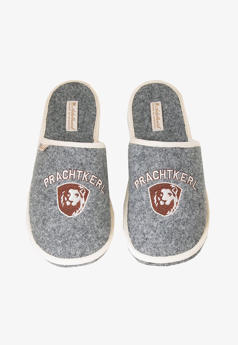 Gray felt slippers with cream accents, featuring a lion emblem and "Prachtkerl" text. Closed-toe design and cushioned interior.