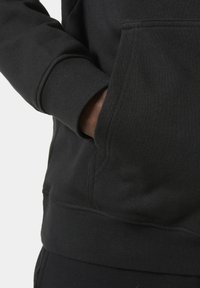 Black hooded sweatshirt featuring a kangaroo pocket, ribbed cuffs, and a soft, textured fabric. The fabric has a matte finish.
