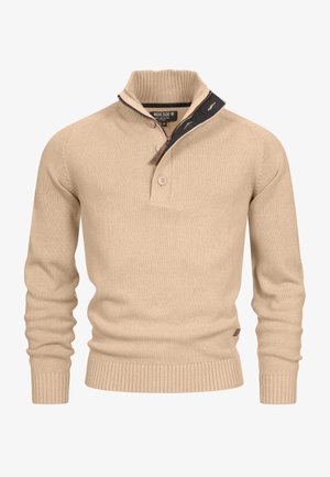 Beige knitted pullover with a high collar, half zip, two buttons, and ribbed cuffs and hem. Features a contrasting dark collar accent.