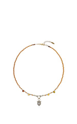 Delicate necklace with small amber beads and a silver pendant shaped like a shield with a gemstone in the center, adjustable gold clasp.