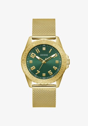 Kuldtooniline võrksangaga rannekell rohelise kellanäidiku, kuldsete numbrite ja kätega, teemantaktsentidega ning "GUESS" logoga keskel.