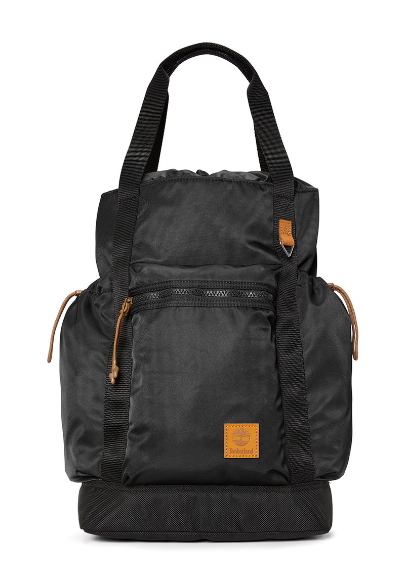 Zaino nero in nylon con manici superiori e spallacci regolabili. Caratterizzato da tasca frontale con zip, dettagli in pelle e sezione inferiore imbottita.