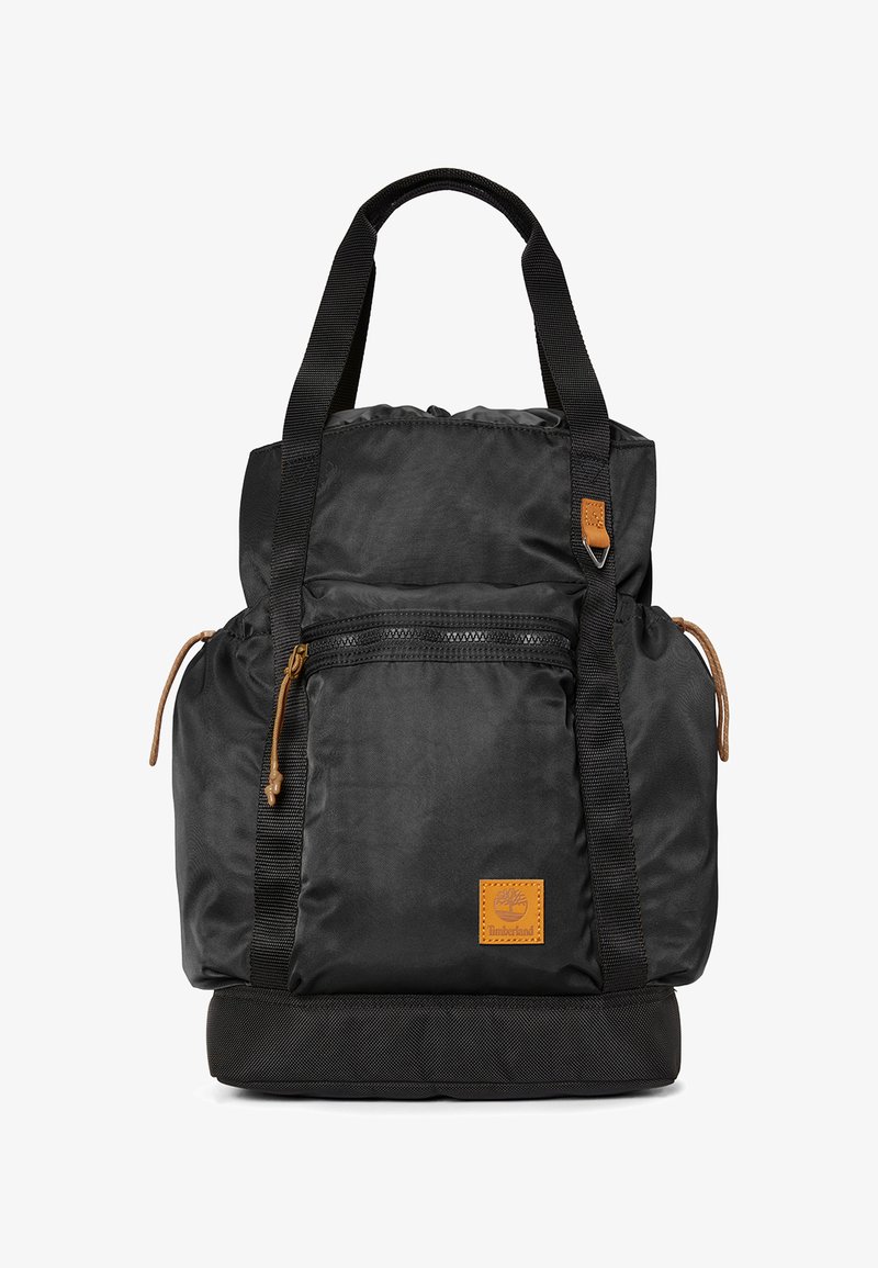 Zaino nero in nylon con manici superiori e spallacci regolabili. Caratterizzato da tasca frontale con zip, dettagli in pelle e sezione inferiore imbottita.