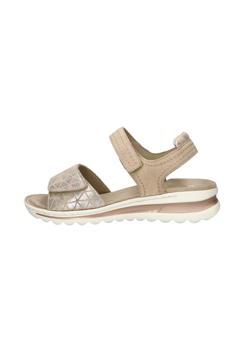 Beige sandal with a textured upper featuring a geometric silver pattern, adjustable strap, and a cushioned white sole.