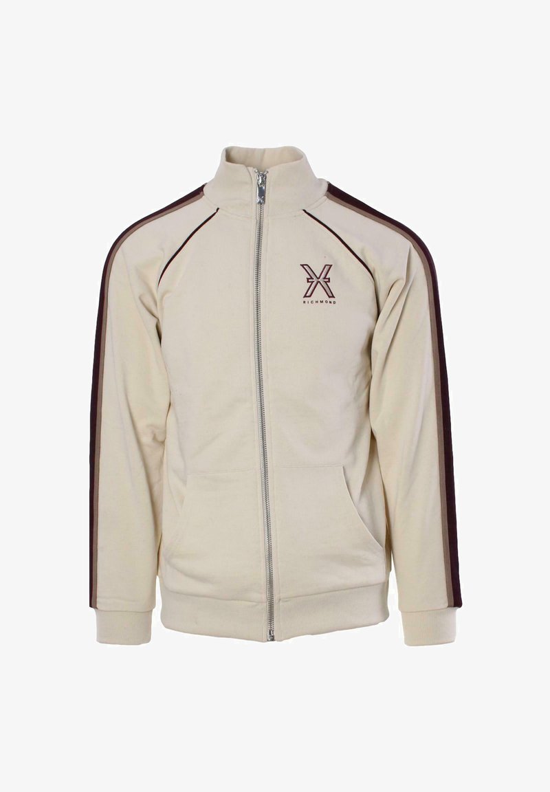 Giacca beige con zip, colletto alto, strisce laterali marroni, tasche frontali e logo sul petto sinistro. Tessuto morbido, vestibilità comoda.